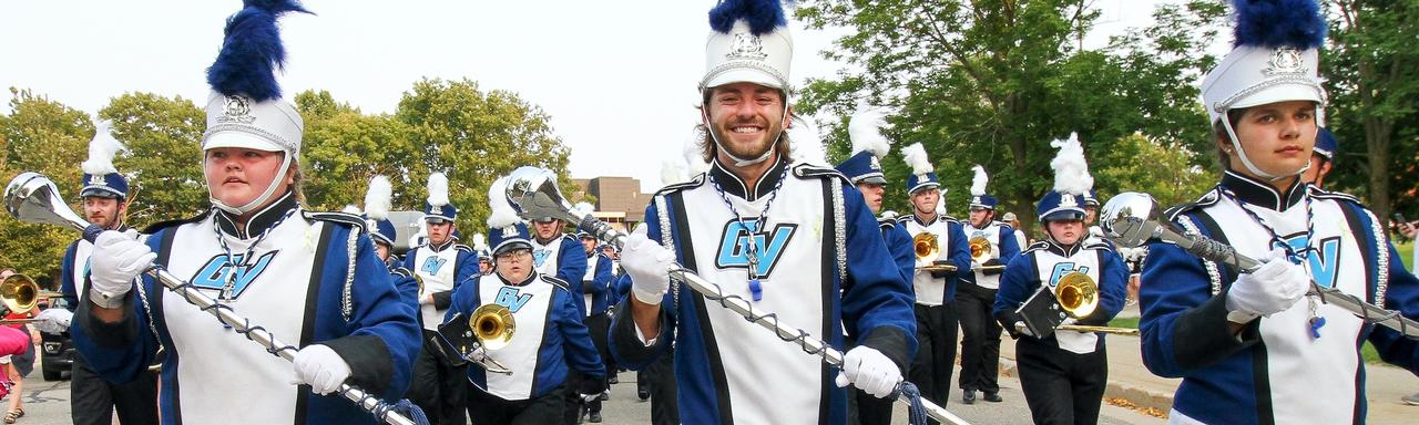 The three drum majors leading the Laker Marching Band as they parade to the Lubbers Stadium